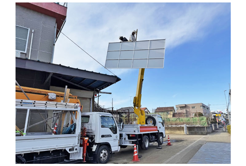高所作業車を利用した倉庫び屋上看板の取付工事